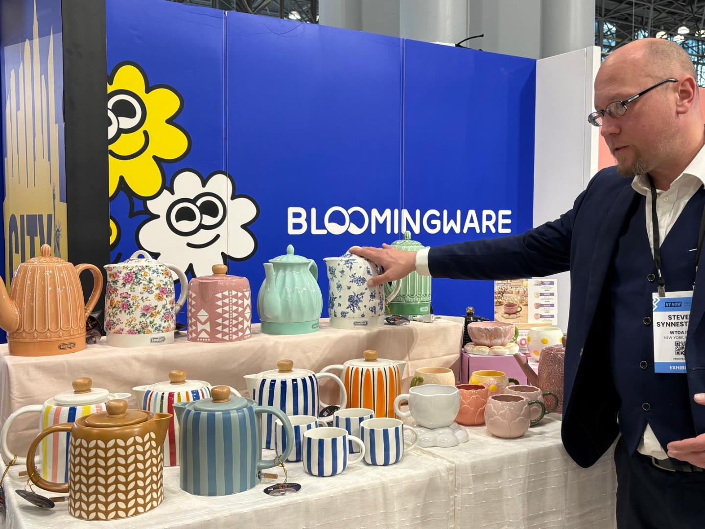 Sales representative showcasing Bloomingware teapots