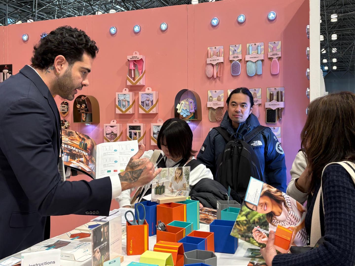 Aqualora sales team presenting catalogs to buyers at NY NOW