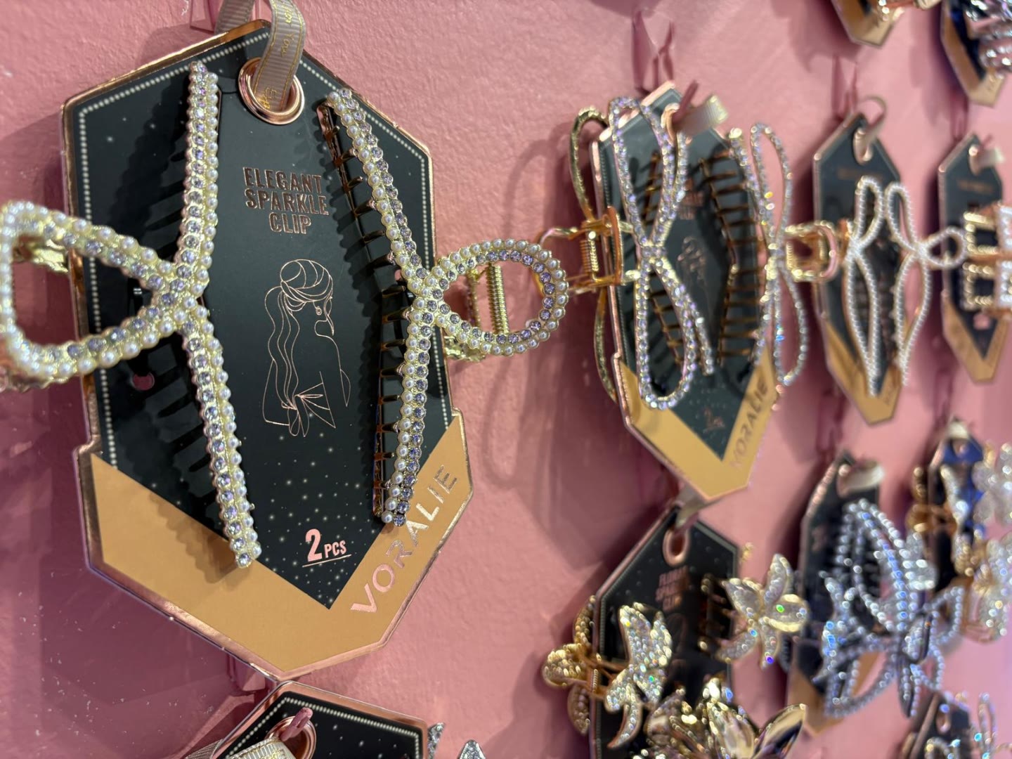 Voralie Elegant Sparkle Clip collection on pink wall